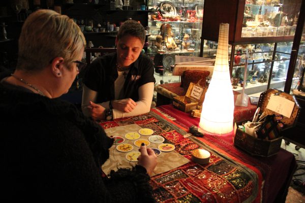 Stacy Cohen, a tarot card reader at Atlantis, performs a reading for her client.PHOTO BY NADIA DELJOU | THE SIGNAL