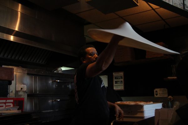 A chef at The Spinning Pie (aka “Spin”) restaurant in Castleberry Hill tosses a pizza in front of customers. Various specialty pizzas like the Caribbean Jerk Chicken pizza are offered at Spin. Photo by Ralph Hernandez | The Signal 