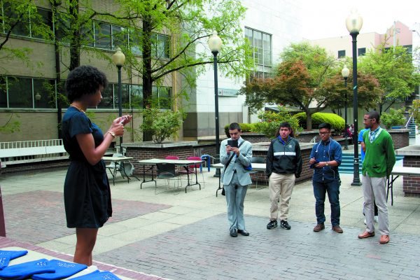Nyomi Haynes announces the winning candidates for the 2015-2016 elections in Library Plaza Monday, April 13th.  Nadia Deljou | The Signal 
