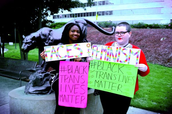 Representatives from Faces of Feminism, Vee McConnell (left) and Tiffani Carroll, show their support for #BlackTransLivesMatter.  Photos by: Justin Clay 