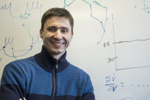 Associate Professor Igor Belykh, who is helping with solving problems the robotic fish project faces, poses in front of a board of his own equations. Photo by Jade Johnson | The Signal 