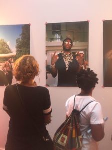 Guests attending Portraits, a photo exhibit showcasing Gunner Stahl work, observe a picture of Hip-Hop artist Gucci Mane