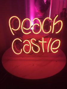 The mellow soft pink decor was complemented by a neon lamp the displayed the name of the photo exhibits host, which was Peach Castle. 
