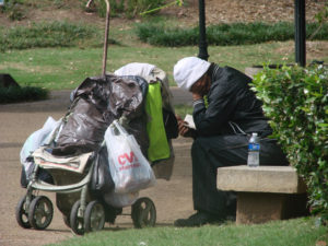 A homeless man reads a book while sitting in Hurt Park. The $2.4 million grant from the U.S. Health Department could potentially help control Atlanta homeless. Signal Archives 