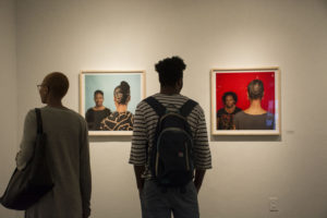 Georgia State students Ashli Trammell and Jarret Goodly view “Hair Craft Project,” on display at the Welch Gallery. Photo by Jade Johnson | The Signal 