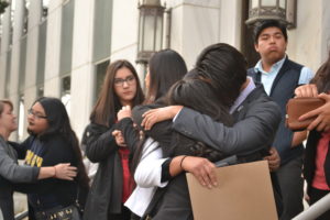 Freedom University students hug after the protest. Photo by: Christina Maxouris | The Signal