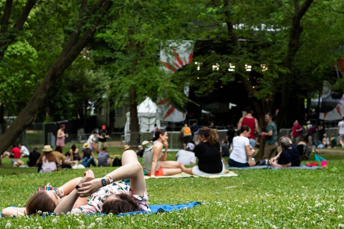 Friends relax in the grass in front of the Criminal Records stage between sets.
Photo by Vanessa Johnson | The Signal