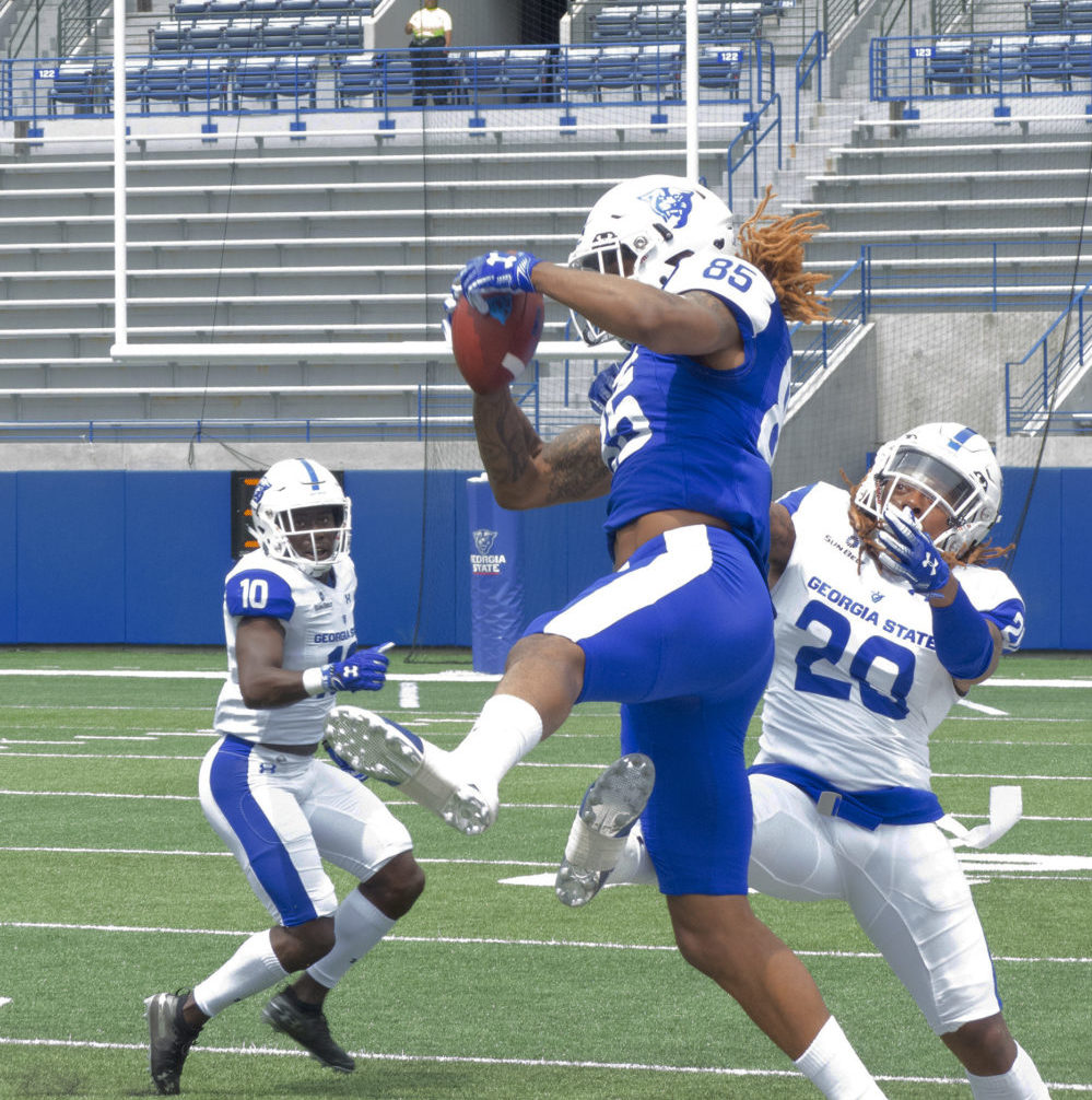 Football player catching a football during a game