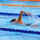 Woman swimming laps in a competition pool. Photo by Marcus Ng on unsplash.com